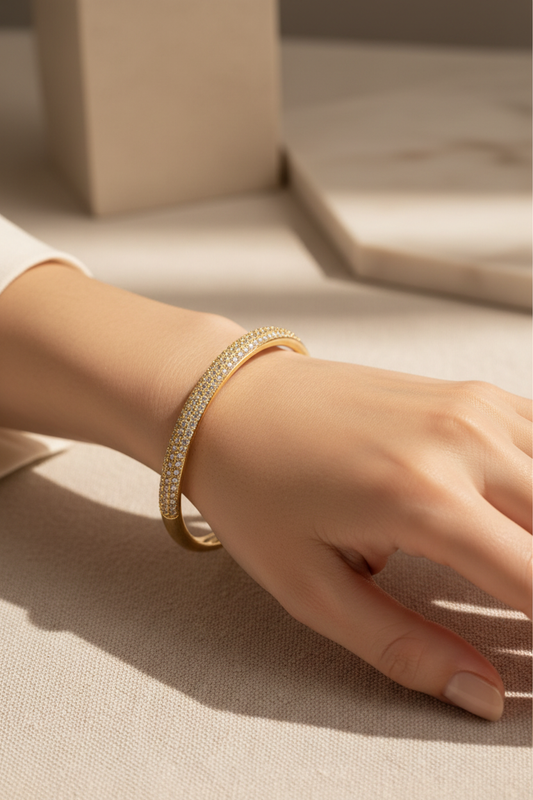 Elegant woman wearing full pavé zirconia gold bangle